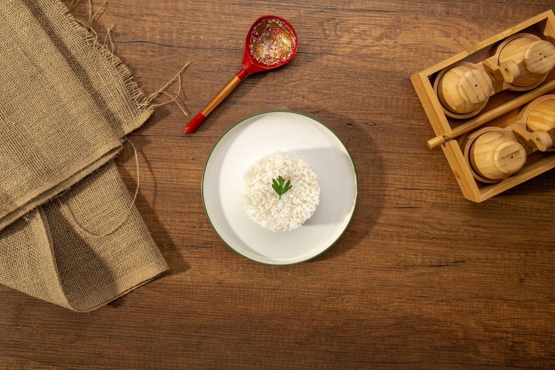 A bowl of white rice with a green garnish